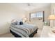 Cozy bedroom with striped bedding and ample natural light at 3800 Bal Harbor Blvd # 312, Punta Gorda, FL 33950