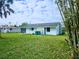 Large backyard with grassy lawn and home view at 683 W Tarpon Nw Blvd, Port Charlotte, FL 33952