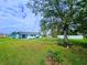 Spacious backyard with grassy lawn and large trees at 683 W Tarpon Nw Blvd, Port Charlotte, FL 33952