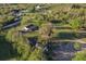 Aerial view showing a house on a spacious lot with lush trees at 1010 Robinhood Dr, Punta Gorda, FL 33982