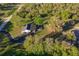 Aerial view of a single story home with a long private driveway at 1010 Robinhood Dr, Punta Gorda, FL 33982