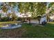 Outdoor entertainment space with fire pit, hammock, and patio at 1010 Robinhood Dr, Punta Gorda, FL 33982