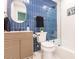 Modern bathroom with blue tile, updated vanity, and shower/tub combo at 1010 Robinhood Dr, Punta Gorda, FL 33982