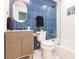 Modern bathroom with blue tile, updated vanity, and shower/tub combo at 1010 Robinhood Dr, Punta Gorda, FL 33982