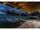 Evening view of covered patio with hammock and lights at 1010 Robinhood Dr, Punta Gorda, FL 33982