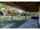 Covered patio with hammock, string lights, and view of yard at 1010 Robinhood Dr, Punta Gorda, FL 33982
