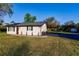 Updated home exterior with a newly paved driveway and landscaping at 1010 Robinhood Dr, Punta Gorda, FL 33982