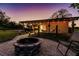 Evening view of backyard with fire pit and hammock at 1010 Robinhood Dr, Punta Gorda, FL 33982