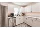 Modern kitchen with white cabinets, stainless steel appliances, and a farmhouse sink at 1010 Robinhood Dr, Punta Gorda, FL 33982