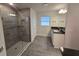 Bathroom features a glass shower stall with gray tiled walls and a white vanity at 14146 Baracoa Ln, Port Charlotte, FL 33981