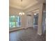 View of the home's entryway featuring decorative lighting and large windows at 14146 Baracoa Ln, Port Charlotte, FL 33981