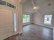 A view of the entryway and adjacent room featuring large windows for an abundance of natural light at 14146 Baracoa Ln, Port Charlotte, FL 33981