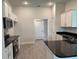 Modern kitchen features sleek black countertops, stainless steel appliances, and white cabinets at 14146 Baracoa Ln, Port Charlotte, FL 33981