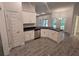View of kitchen with white cabinets, dark granite countertops, stainless steel appliances, and tile floors at 14146 Baracoa Ln, Port Charlotte, FL 33981