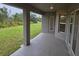 Covered back patio with lush backyard views at 14146 Baracoa Ln, Port Charlotte, FL 33981