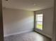 Bedroom featuring gray walls, wood-look tile flooring and a window providing natural light at 14154 Baracoa Ln, Port Charlotte, FL 33981