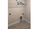 Bright laundry room featuring tile flooring and a wire shelf for storage at 14154 Baracoa Ln, Port Charlotte, FL 33981