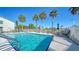 Refreshing community pool with ample seating and palm trees at 1452 San Cristobal Ave # B103, Punta Gorda, FL 33983