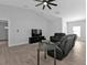 Living room with vaulted ceiling, ceiling fan, and black leather furniture at 17494 Iago Ave, Port Charlotte, FL 33954