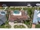 Bird's-eye view of a luxurious home, pool, and landscaping at 1925 Jamaica Way, Punta Gorda, FL 33950