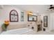 Bathroom with garden tub, double vanity, and decorative accents at 1925 Jamaica Way, Punta Gorda, FL 33950