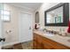 Bathroom boasts wood vanity, granite countertop, and slate tile floor at 1925 Jamaica Way, Punta Gorda, FL 33950