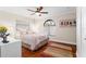 Bright bedroom with hardwood floors, ceiling fan, and neutral decor at 1925 Jamaica Way, Punta Gorda, FL 33950