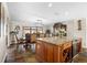 Kitchen dining area with granite island, wood cabinets, and chandelier at 1925 Jamaica Way, Punta Gorda, FL 33950