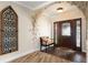 Bright and airy entryway with decorative wall art and a comfortable bench at 1925 Jamaica Way, Punta Gorda, FL 33950