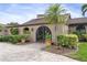 View of the home's entrance with a decorative iron gate at 1925 Jamaica Way, Punta Gorda, FL 33950