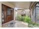 Welcoming front entrance with a wooden door and lush landscaping on either side at 1925 Jamaica Way, Punta Gorda, FL 33950