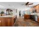 Island kitchen with granite countertops, wood cabinets, and stainless steel appliances at 1925 Jamaica Way, Punta Gorda, FL 33950