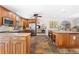 Modern kitchen with wood cabinets, granite countertops, and island at 1925 Jamaica Way, Punta Gorda, FL 33950