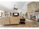 Living room with a large TV, comfortable seating, and a stone fireplace at 1925 Jamaica Way, Punta Gorda, FL 33950
