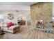 Spacious living room with a large stone fireplace and comfortable seating at 1925 Jamaica Way, Punta Gorda, FL 33950