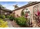 Landscaped walkway leading to the entrance with decorative arches and lush foliage at 1925 Jamaica Way, Punta Gorda, FL 33950