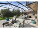 Spacious screened patio featuring comfortable seating and dining areas at 1925 Jamaica Way, Punta Gorda, FL 33950