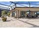 Relaxing screened patio with seating area, pavers, and lush landscaping at 1925 Jamaica Way, Punta Gorda, FL 33950