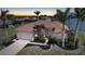 Charming single-Gathering home with a tile roof, two-car garage, and lush landscaping at sunset at 24282 Silver Ln, Punta Gorda, FL 33955