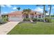 Charming single-story home featuring a red tile roof, an attached garage, and meticulously kept landscaping at 24282 Silver Ln, Punta Gorda, FL 33955