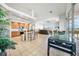 Open concept kitchen with breakfast bar, living room and pool view at 24282 Silver Ln, Punta Gorda, FL 33955