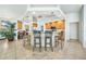 Kitchen boasts an island with seating and wood cabinetry at 24282 Silver Ln, Punta Gorda, FL 33955