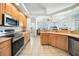Open kitchen with island and breakfast bar, stainless steel appliances at 24282 Silver Ln, Punta Gorda, FL 33955