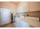 Bright laundry room with washer, dryer, and storage cabinets at 24282 Silver Ln, Punta Gorda, FL 33955