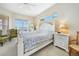 Bright and airy main bedroom with water views and plush bedding at 24282 Silver Ln, Punta Gorda, FL 33955