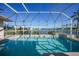 Screened-in pool with water view; a perfect outdoor oasis at 24282 Silver Ln, Punta Gorda, FL 33955