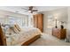 Main bedroom with king bed, wood armoire, and window seating at 2813 Sancho Panza Ct, Punta Gorda, FL 33950