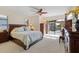 Main bedroom with plush carpet, king-size bed, and access to backyard at 2813 Sancho Panza Ct, Punta Gorda, FL 33950