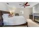 Bedroom with king-size bed, fireplace, and ceiling fan at 2813 Sancho Panza Ct, Punta Gorda, FL 33950
