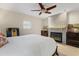 Bedroom with king-size bed, fireplace, and ceiling fan at 2813 Sancho Panza Ct, Punta Gorda, FL 33950